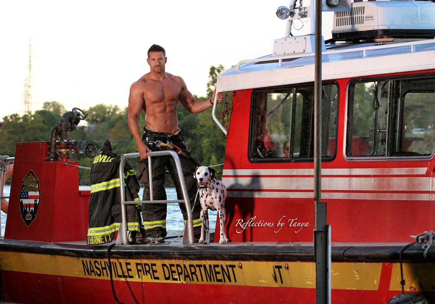 Man standing on a Nashville Fire Department boat with a dog.